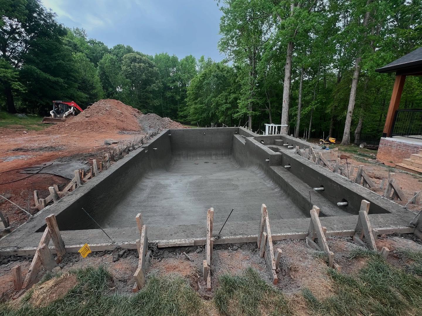 Freshly poured gunite pool shell curing