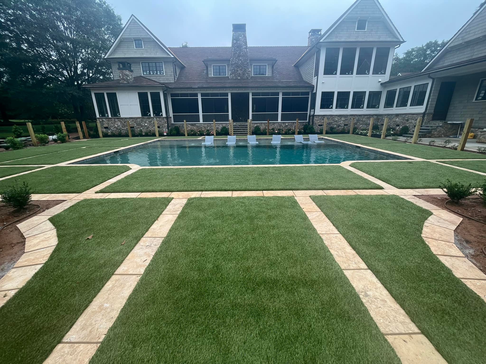 Luxury estate pool with turf and geometric hardscape